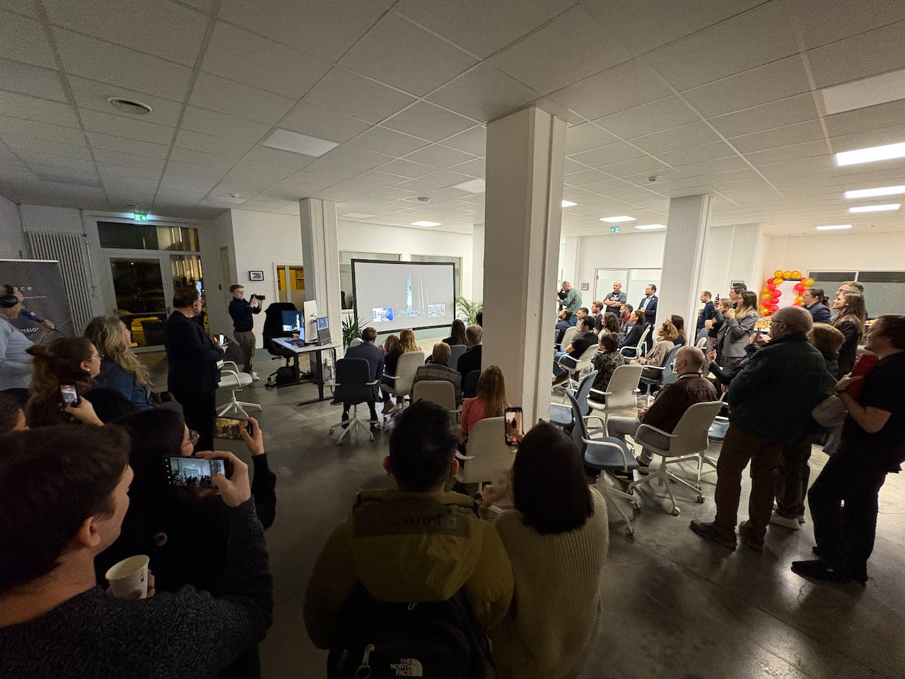 Attendees at Ispace Luxembourg’s HQ applaud the moment a SpaceX rocket carrying Ispace’s lunar lander blasts off, 15 January 2025. Photo: Maison Moderne
