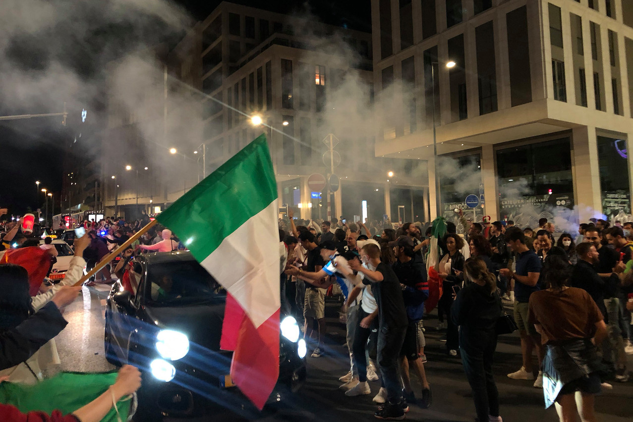 Italian fans on the boulevard Royal in Luxembourg City form an honour guard for cars tooting their horns in celebration of their team’s Euro2020 victory on Sunday night. Matic Zorman