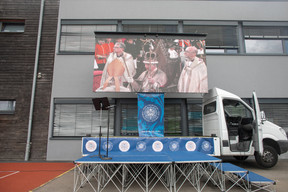 The coronation service of King Charles III and Queen Camilla, shown on screens during an event at St George’s International School in Luxembourg on 6 May. Photo: Matic Zorman / Maison Moderne