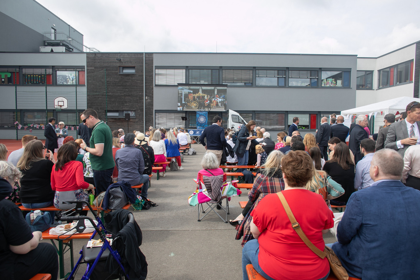 People gathered at St George’s International School in Luxembourg to celebrate the coronation of King Charles III and Queen Camilla on 6 May 2023, which was shown on a large screen. Photo: Matic Zorman / Maison Moderne