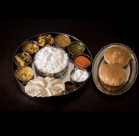 Sample of the thali in special trays and plates imported from India. Krishna Vilas
