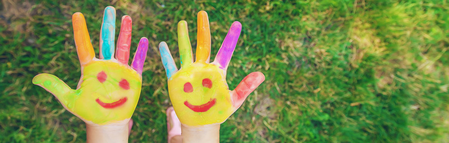 Children's hands in the colors of summer. Selective focus.arts Photo: Shutterstock.