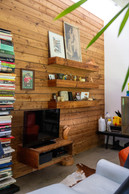 Upstairs, a wooden block has been added to the space, allowing a TV room to be combined on the front, children's bedrooms and bathroom on the inside, and parents' bedroom on the top. Photo: Eva Krins