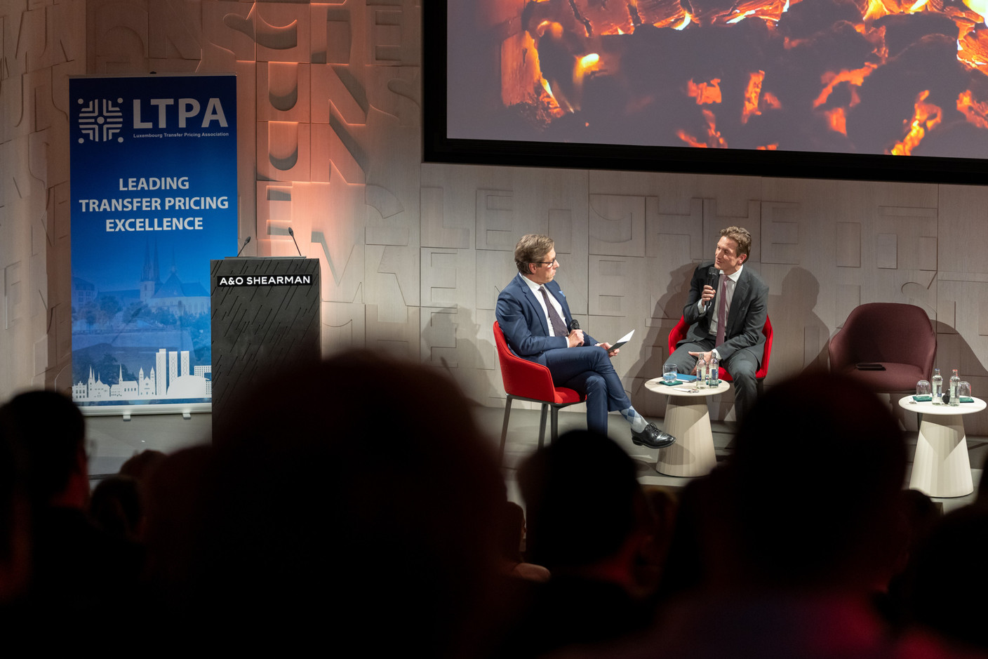 Jean Schaffner (A&O Shearman) and Luxembourg Inland Revenue (ACD) director Jean-Paul Olinger had a fireside chat on the transfer pricing landscape during the official launch ceremony of the Luxembourg Transfer Pricing Association, held at A&O Shearman, 25 February 2025. Photo: Emmanuel Claude/Focalize