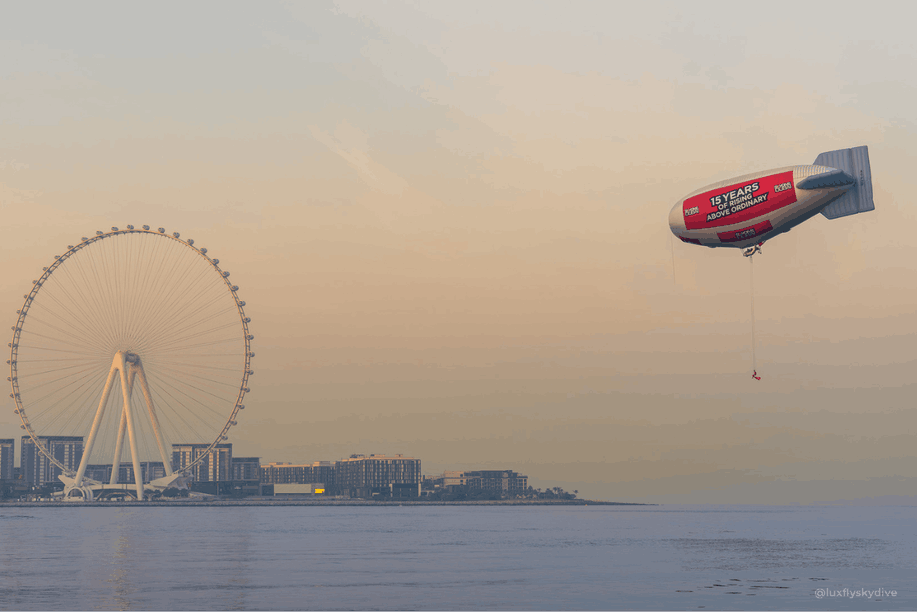 Suspended under an airship at an altitude of more than 300 metres, Magali Braff performed a stunt never before attempted: evolving on an aerial swing above Dubai before jumping in a BASE jump in a dress specially designed for the occasion. Photo: ©Luxflyskydive - Steve Braff for @skydivedubai