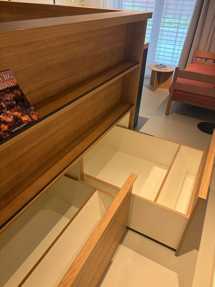 The pull-out storage space under the bed allows you to hide bulky suitcases and unsightly shoes. (Photo: Alix Bellac)