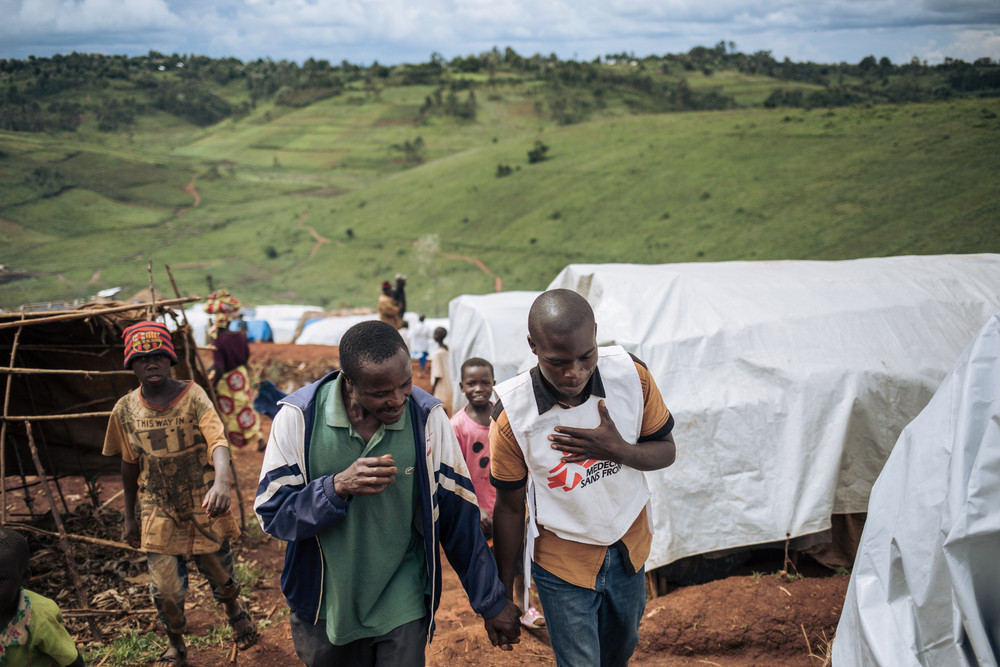 Emmanuel Grorima Jilo (left), 42, speaks with Flauribert, an MSF health promoter, next to where his shelter was destroyed during the late September attack on the Rho IDP site, Djugu territory, Ituri province, DRC, 11 November 2019. Photo: Alexis Huguet 