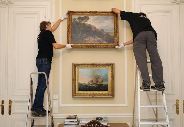 
	Staff installing a painting at the British ambassador’s official residence
 Steve Eastwood