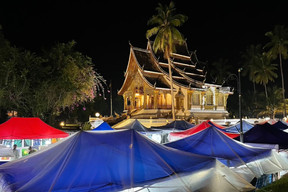Haw Pha Bang temple in the grounds of the former royal palace in Luang Prabang with tents from the daily night market. Photos: Cordula Schnuer