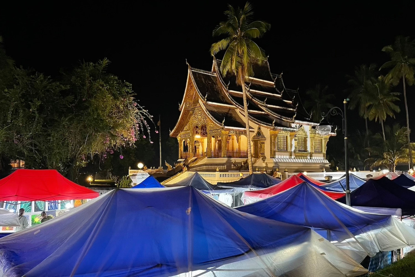 Haw Pha Bang temple in the grounds of the former royal palace in Luang Prabang with tents from the daily night market. Photos: Cordula Schnuer