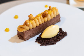 Salted butter caramel chocolate entremet, creamy chocolate cake, compact mousse, passion fruit coulis, chocolate crumble. Photo: Guy Wolff/Maison Moderne