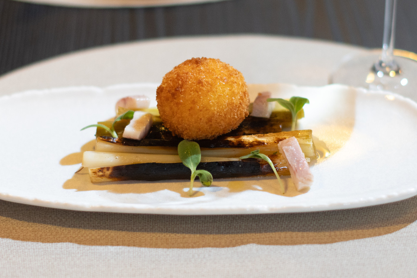 Barbecued leeks, crispy soft-boiled egg and smoked eel. Photo: Guy Wolff/Maison Moderne