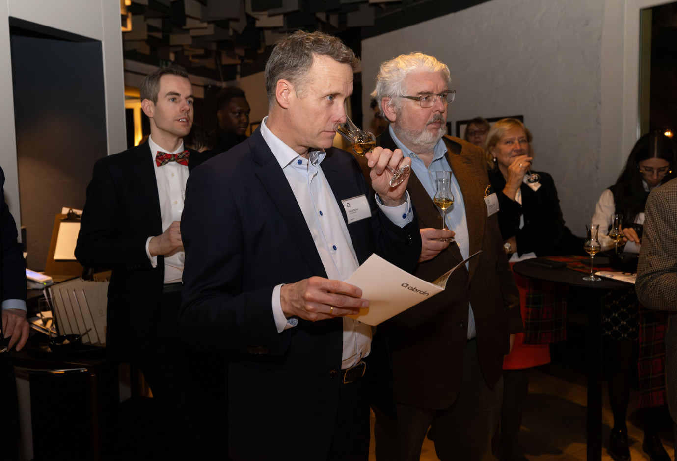 Francois-Xavier Diricks (Abrdn), Patrick Becker (CA Indosuez) and Peter Duynslaeger (CA Indosuez) listen to whisky expert Stuart Cassells explain how to identify the aromas and flavours when whisky tasting. Photo: Guy Wolff/Maison Moderne