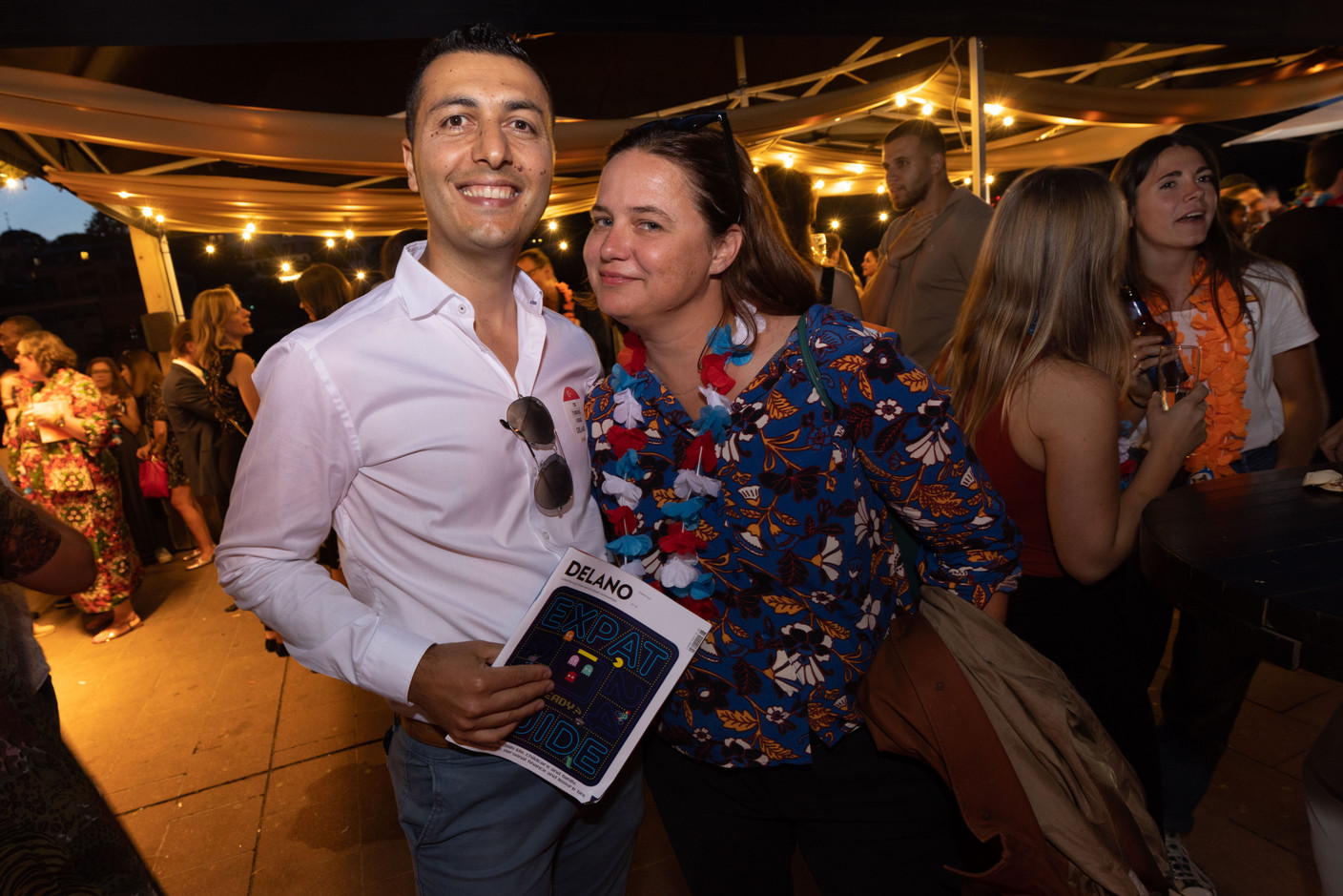 Abidin Karabulut holding a copy of the Delano Expat Guide 2023-24 hot off the presses and Natalie Gerardstein (Arendt & Medernach). Photo: Guy Wolff/Maison Moderne