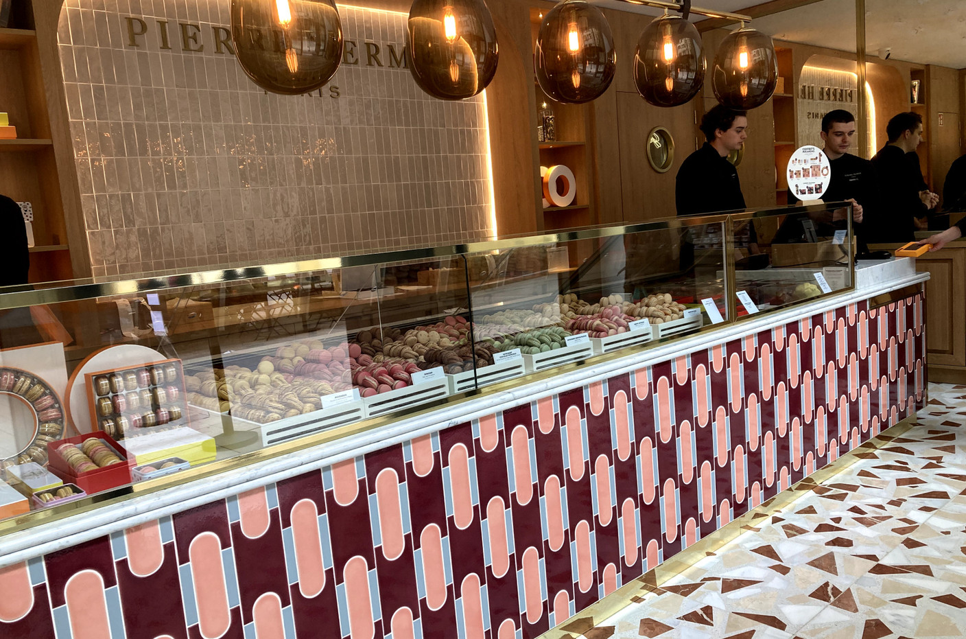 A long glass counter displays the macarons, the house speciality. Photo: Paperjam