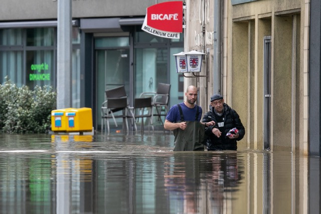 People wading up to their waist in flood waters on the place d’Argent in Luxembourg City on Thursday 15 July 2021 Matic Zorman