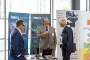 David Wright of Funds Europe is seen speaking with Alfi deputy director general Marc-André Bechet. Photo: Romain Gamba/Maison Moderne