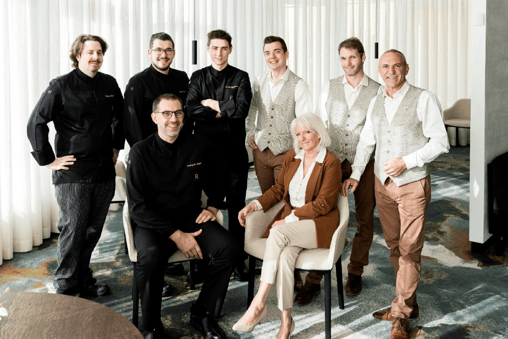 Thierry Corona, far right, is accompanied by the Roses kitchen team on the left, and the dining room team, in their new outfits, on the right. Casino2000
