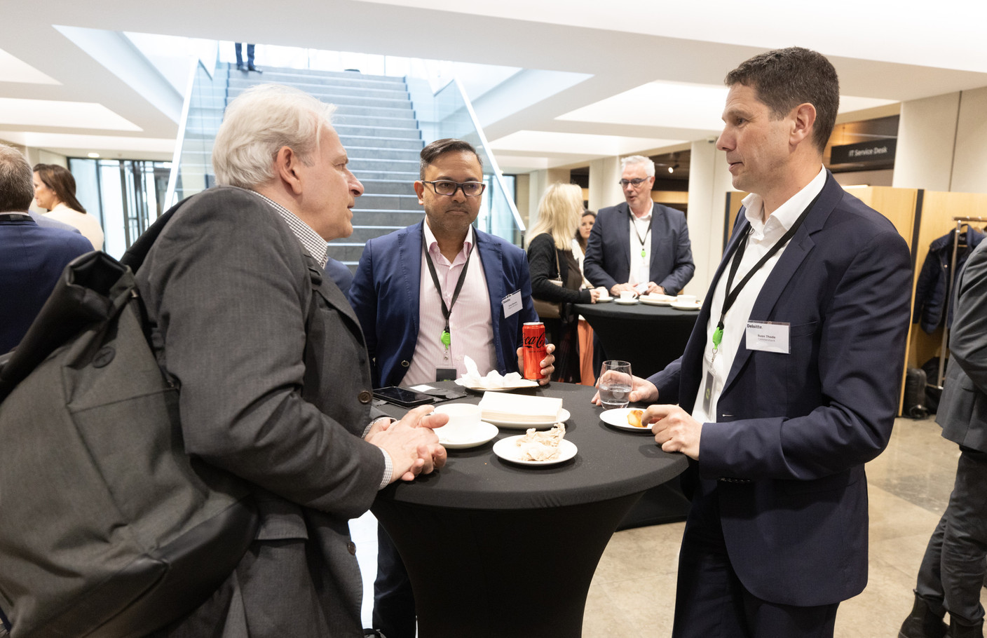Attendees had the opportunity to network at Deloitte’s sustainable finance conference, 18 April 2024. Eros Sharma (Odgers Berndtson) in the centre, Sven Thode (Commerzbank) on the right. Photo: Guy Wolff/Maison Moderne