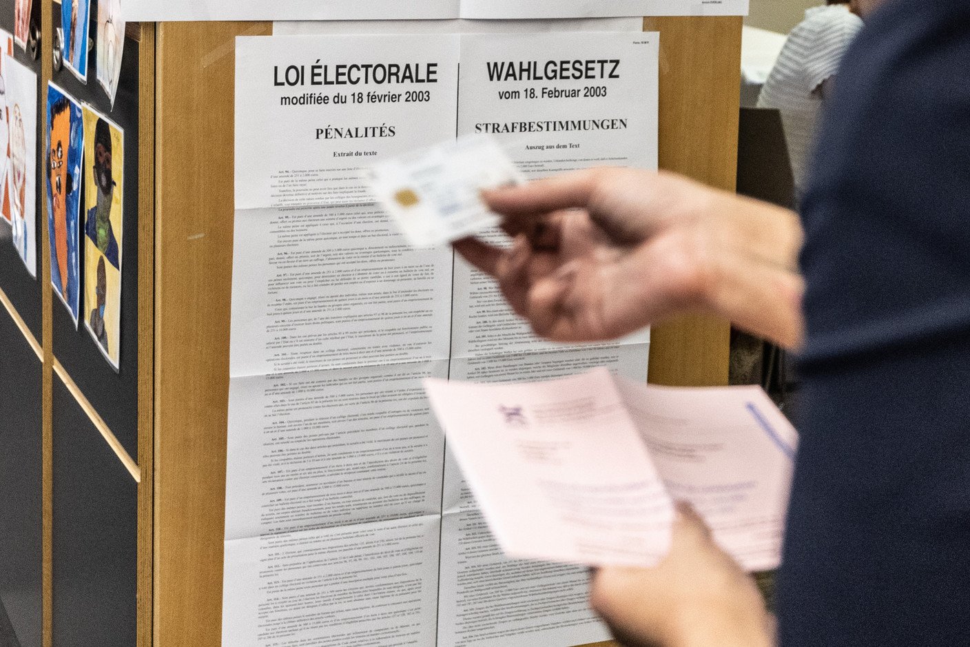 Poll workers check voters’ documents during Luxembourg’s local elections, in Esch-sur-Alzette, 11 June 2023. Photo: Guy Wolff/Maison Moderne