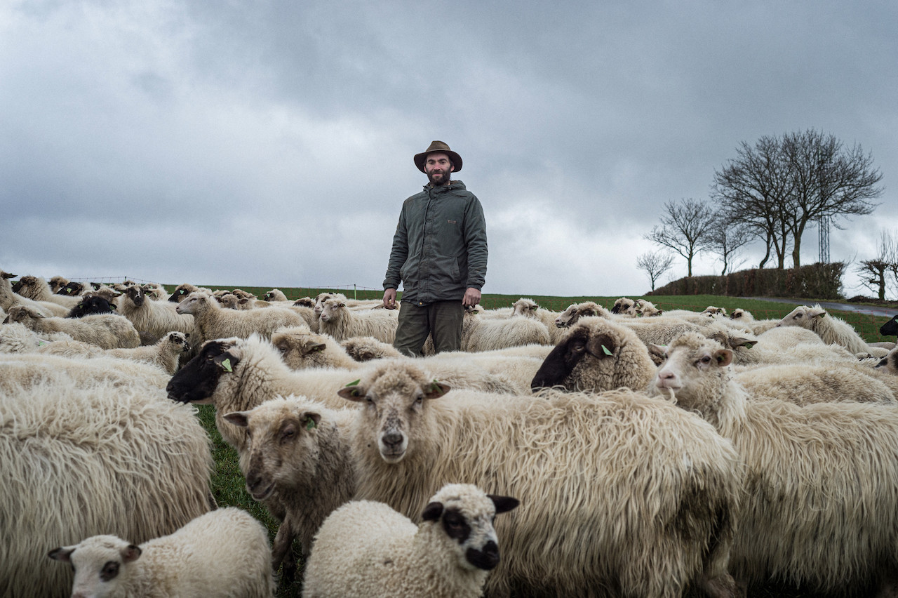Florian Weber, pictured for Delano in February 2020, and some of the sheep that he moves around the grand duchy as part of his transhumance practice that promotes biodiversity.  MIKE ZENARI