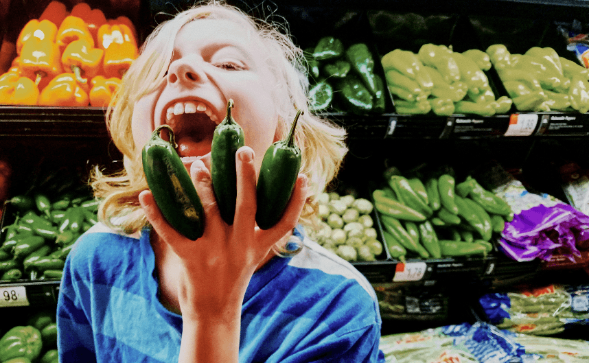 YOUNG WOMAN WITH VEGETABLES AT MARKET Copyright © 2017, Sharon McCutcheon, licensed via EyeEm Mobile GmbH