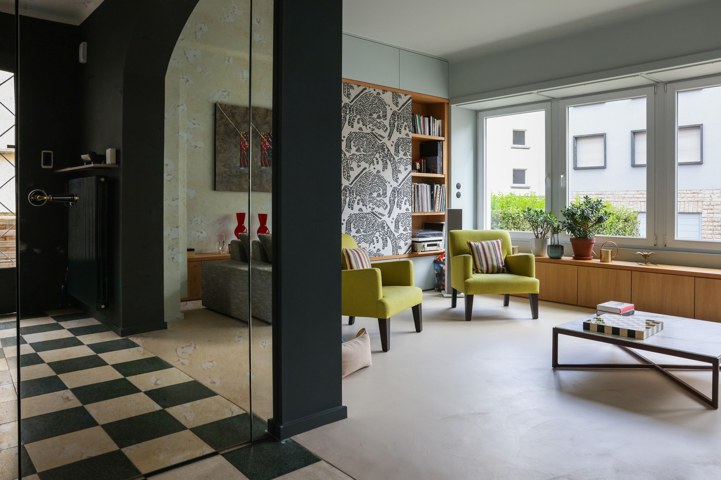 In the living room, the television is hidden by a panel covered in a graphic tapestry that adds character and warmth to the space. Photo: Marie Russillo/Maison Moderne