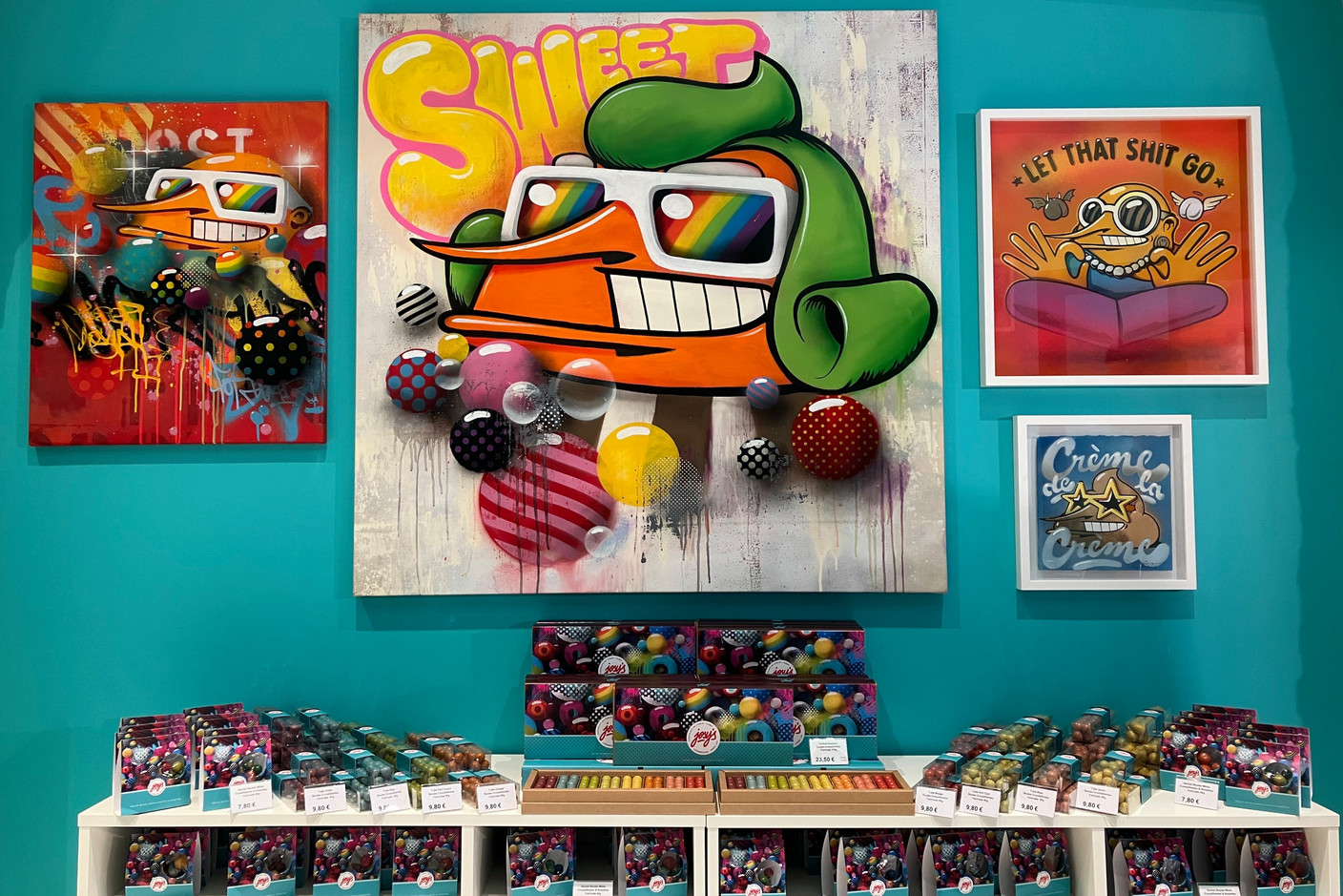 A large square canvas featuring Sumo’s Crazy Baldhead character as a glasses-wearing green-haired Oompa-Loompa, the creatures who work in Willy Wonka’s chocolate factory, hangs on the right wall of the pop-up store. Photo: Lydia Linna/Maison Moderne