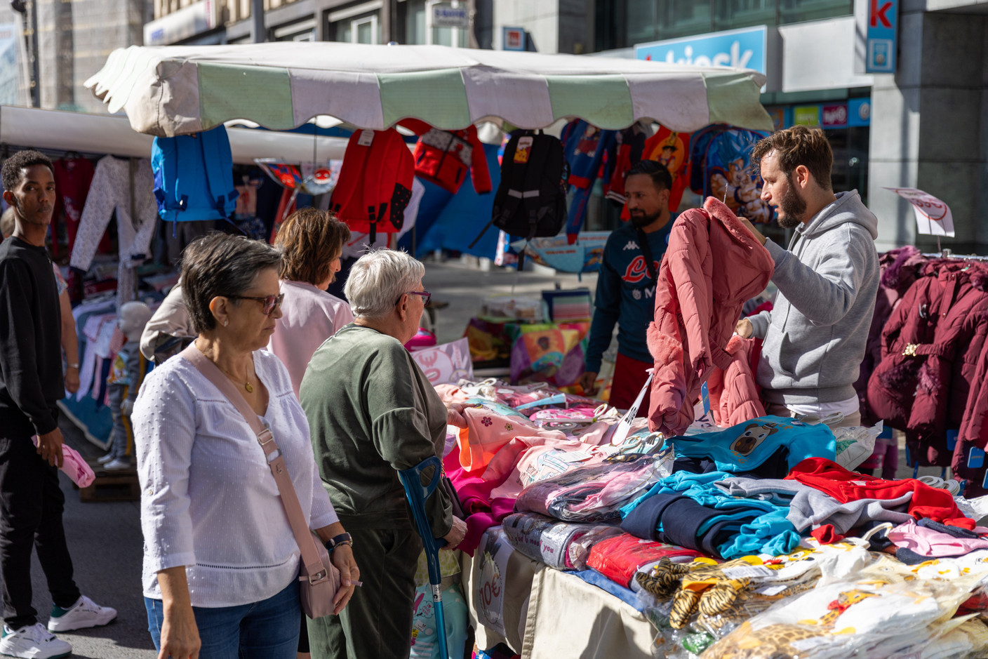 Shoppers and stallholders are seen in the Gare district during the braderie (street market) in Luxembourg City, 4 September 2023. Photo: Romain Gamba / Maison Moderne
