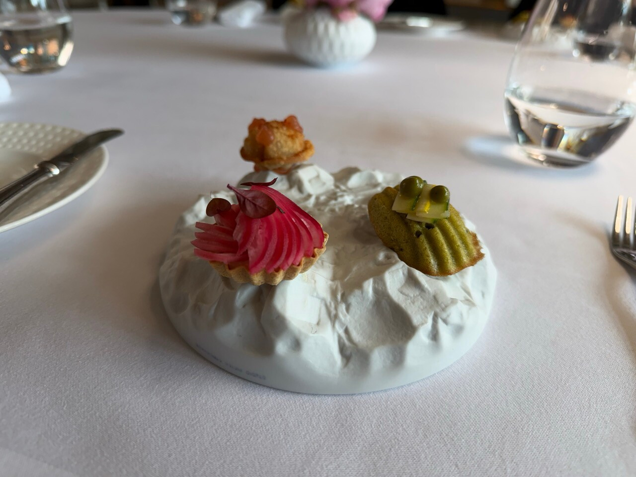Savoury courgette and Comté cheese madeleines, tartlets with cream and pickled radishes, and soufflé pizza: Chef Milan Brée’s appetisers at La Cristallerie. Photo: Emilie Gline/Paperjam