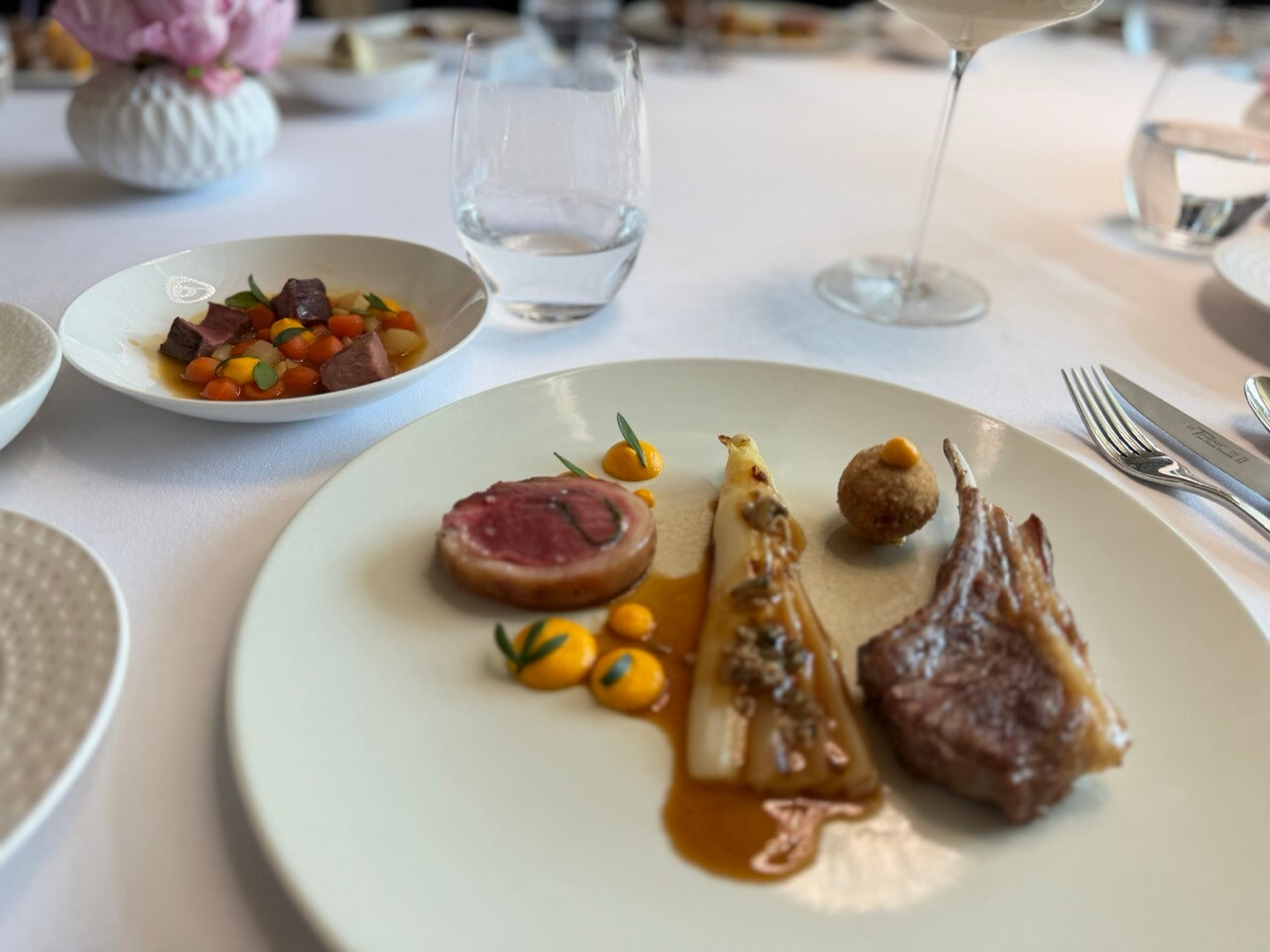Lamb chops and saddle of lamb, confit shoulder cromesquis, roasted white asparagus, carrot purée and lamb and oyster jus: the main course on the Éclat menu at La Cristallerie. Photo: Emilie Gline/Paperjam