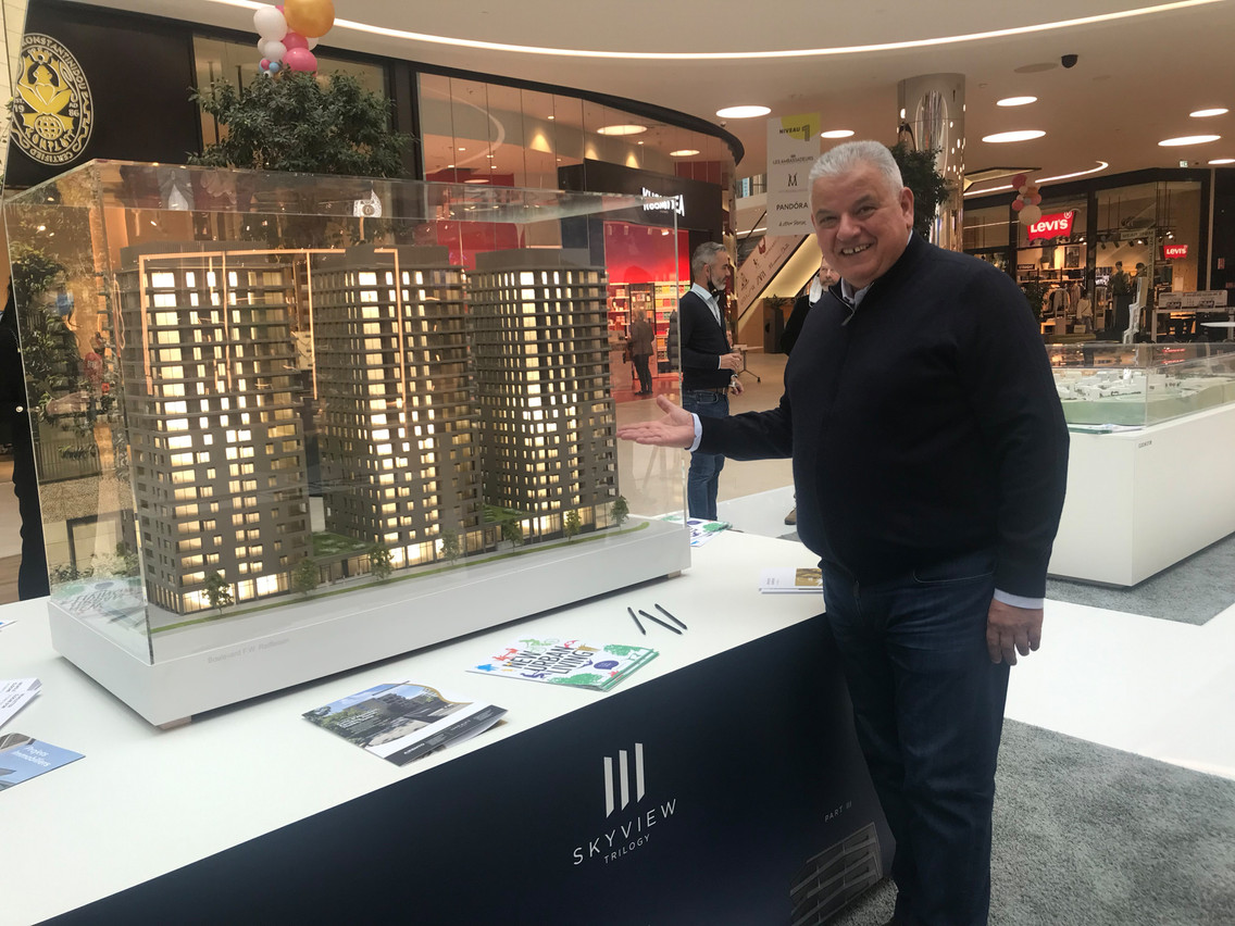 Flavio Becca in front of the model of the Skyview Trilogy residential towers presented at the Move fair in the Cloche d’Or shopping centre. Photo: Maison Moderne