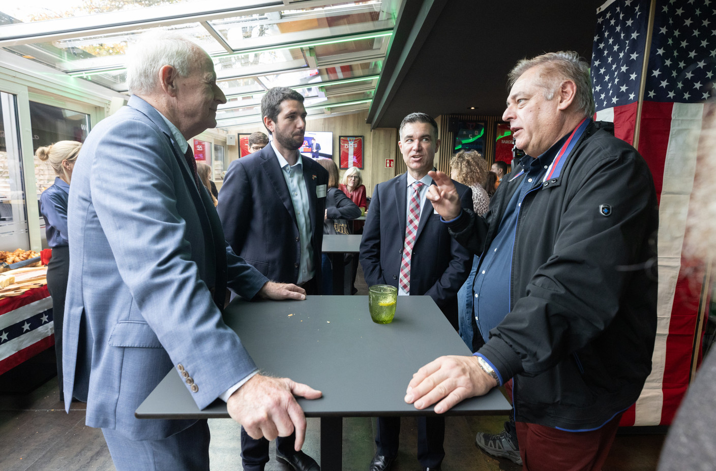 Tom Barrett (US ambassador to Luxembourg), Jeff Schlink (US embassy), Marcus Chaney (political and economic officer at the US embassy), Daniel Mckenzie (Amcham) at the US election watch party held at The Spot in Luxembourg City, 6 November 2024. Photo: Guy Wolff/Maison Moderne)