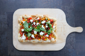 La pinsa bianca semplice, topped with cherry tomatoes, mozzarella, garlic, basil and olive oil Marie Russillo (Maison Moderne)