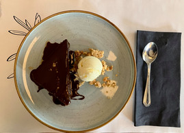 Karidopita, a traditional Greek walnut cake imbibed with syrup and cardamom, served with chocolate sauce, vanilla ice cream and hazelnut granola. Photo: Lydia Linna/Maison Moderne