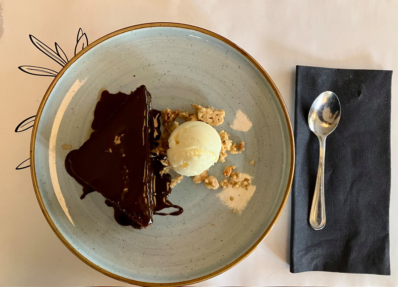 Karidopita, a traditional Greek walnut cake imbibed with syrup and cardamom, served with chocolate sauce, vanilla ice cream and hazelnut granola. Photo: Lydia Linna/Maison Moderne