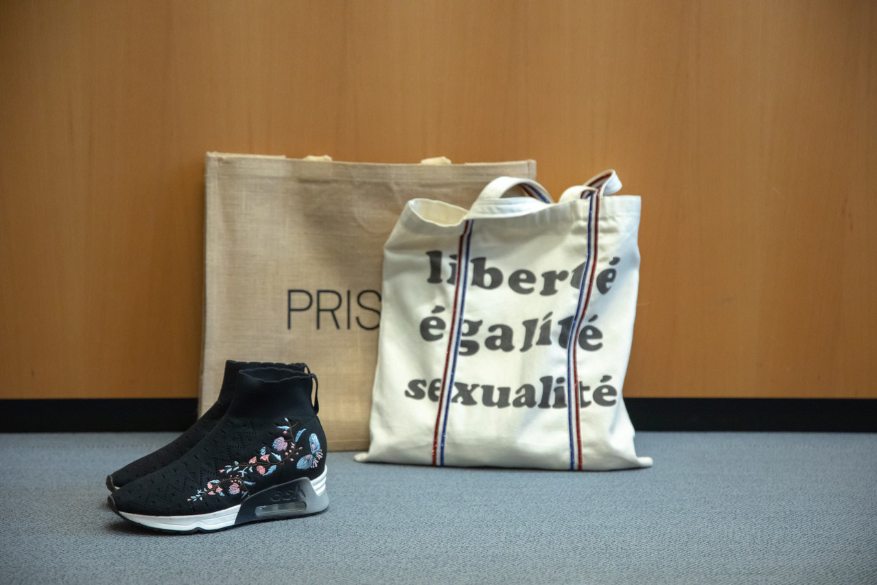 Lying right next to her desk was a pair of shoes and a pair of shopping bags, one of which (“Liberté, égalité, sexualité”) is actually her laptop bag. Photo: Matic Zorman