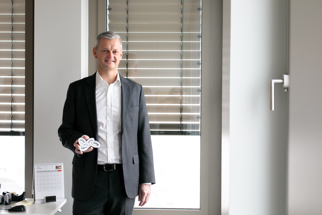 Alan Dundon of Alter Domus and the Luxembourg Alternative Administrators Association (L3A) poses with a sculpture signifying the value of teamwork. Photo: Matic Zorman