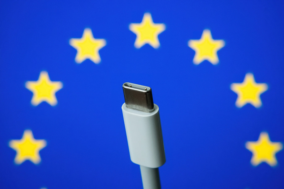 Concept for EU law to force USB-C chargers for all phones. EUROPEAN UNION flag and USBC universal charging cable. Selective focus. Copyright (c) 2021 mundissima/Shutterstock.  No use without permission.